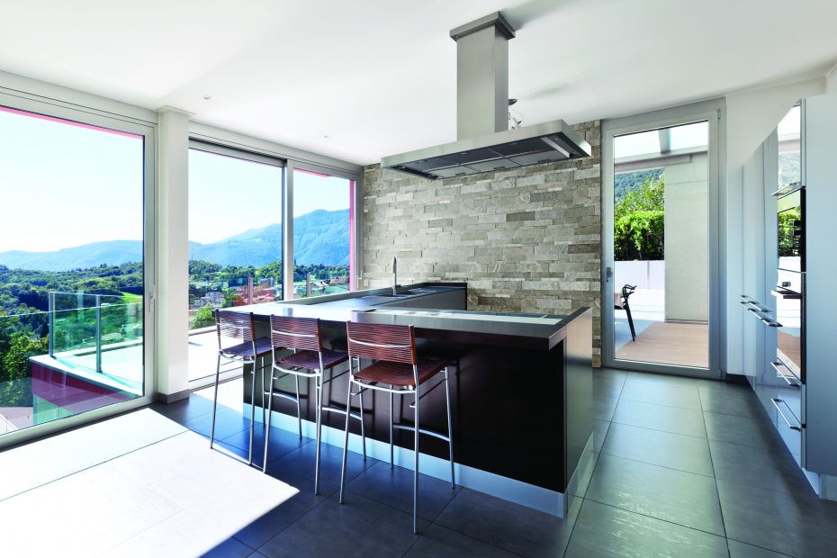 dark tile flooring in a kitchen with floor to ceiling windows